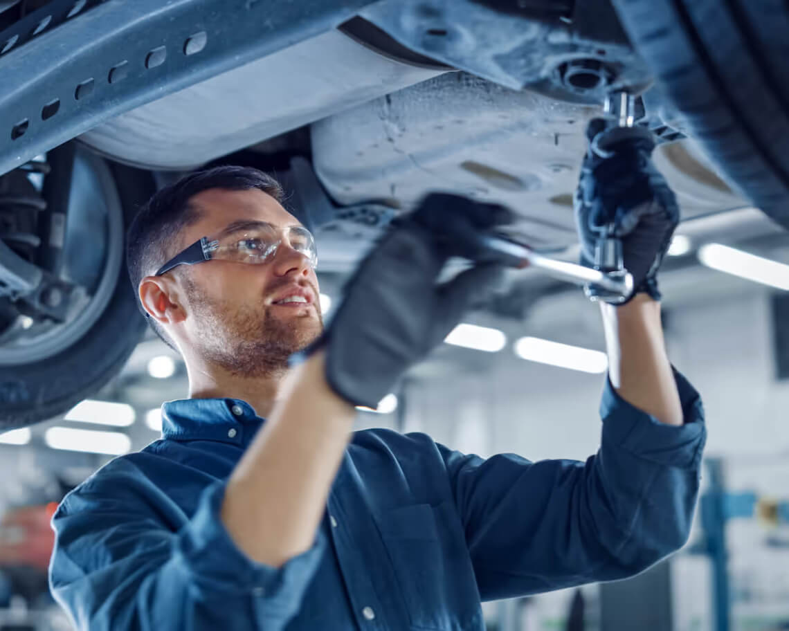 Kia Service Technician Working under a Kia
